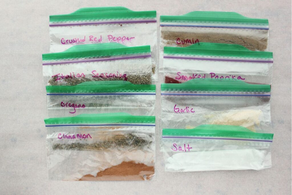 Pre-portioned spices packed in labeled ziplock bags for cooking safely in vacation rentals with food allergies