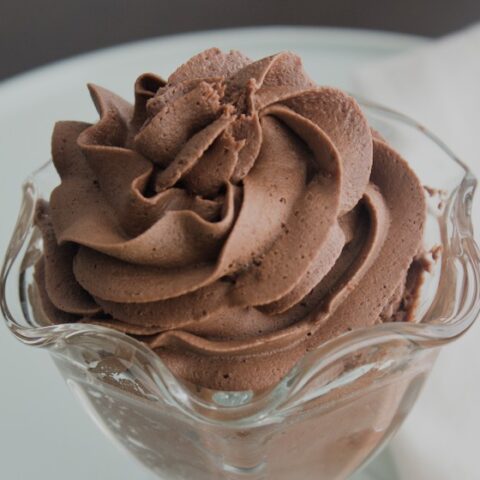 Dairy free chocolate frosting without butter piped into a glass dessert dish