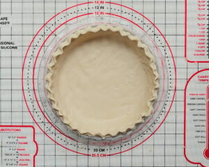 Finished gluten-free pie crust pressed into a pie pan and ready for filling, viewed from above
