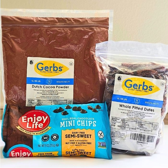 Packages or Gerbs Cocoa Powder, Gerbs Pitted Dates, and Enjoy Life Chocolate Chips arranged in a group