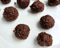 balls of date truffle filling on a white tray