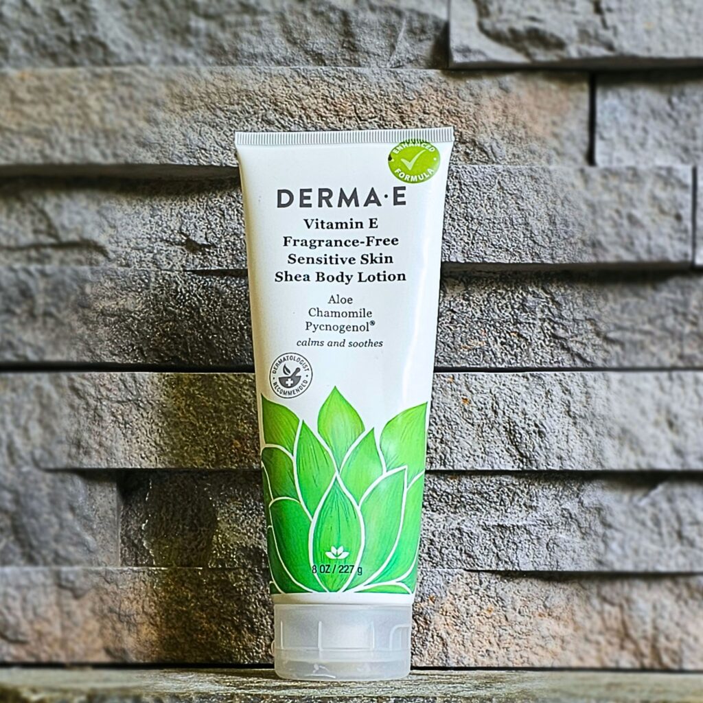 Derma E Sensitive Skin Body Lotion on a stone shelf
